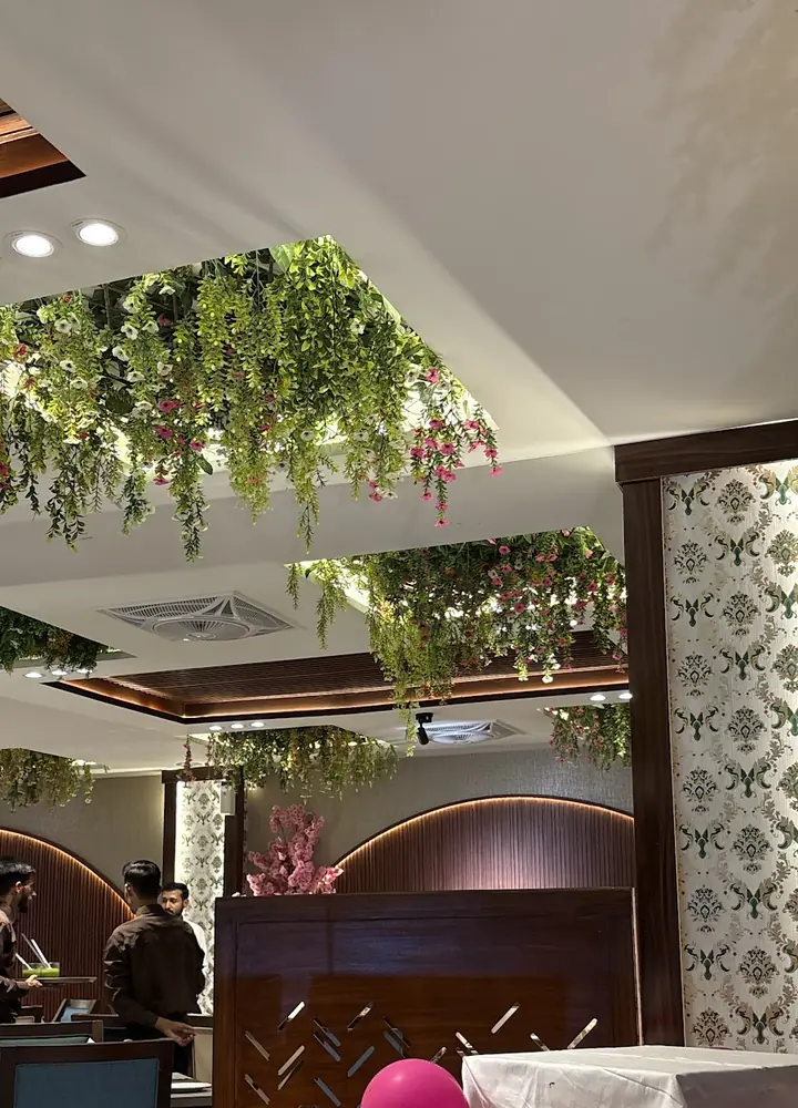 The dining room with hanging greenery and warm lights